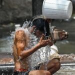 person drinking water hot summer sun dehydration india heatwave