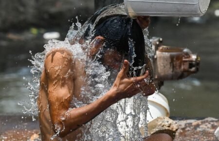 person drinking water hot summer sun dehydration india heatwave