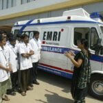 Ambulance vehicle outside a hospital during emergency healthcare operations in India.