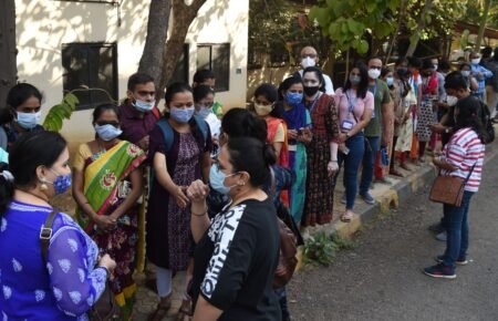 Healthcare workers conducting a vaccination awareness and outreach campaign in India.