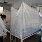 Health worker conducting dengue prevention and mosquito control activities in India.