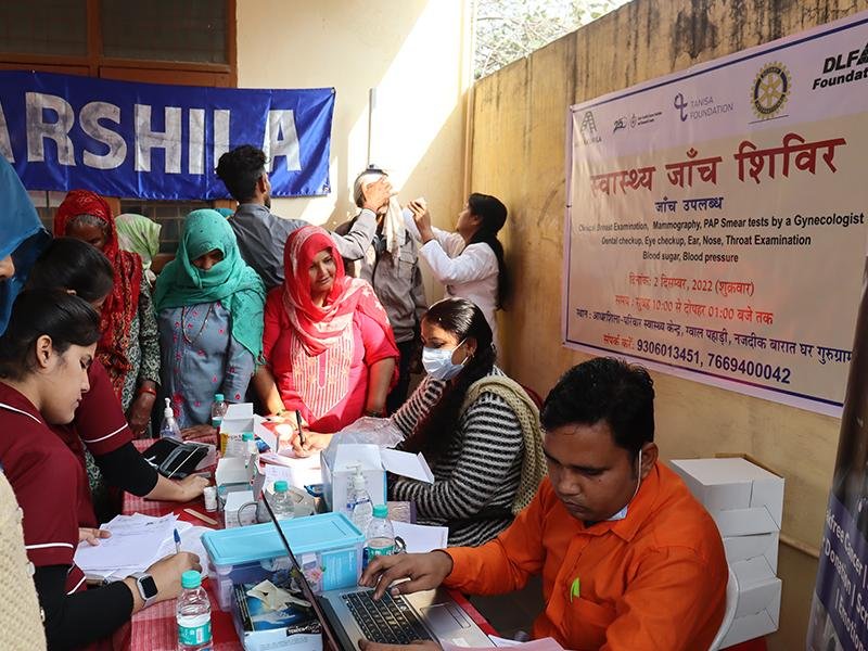 Doctors conducting community health screening and medical check-ups in India.