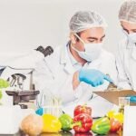Food safety officer conducting hygiene inspection at a food establishment in India.