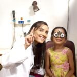 Eye doctor examining a child during a vision check-up in Telangana.