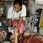 Healthcare professionals treating patients during extreme summer heat conditions.