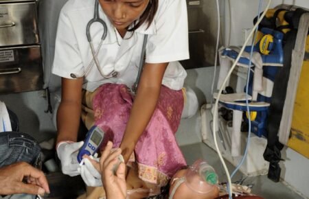 Healthcare professionals treating patients during extreme summer heat conditions.
