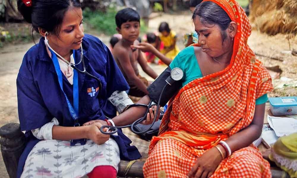 Health workers conducting community health screening in a rural area of Chhattisgarh.
