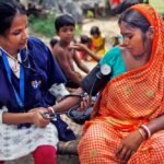 Health workers conducting community health screening in a rural area of Chhattisgarh.