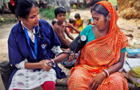 Health workers conducting community health screening in a rural area of Chhattisgarh.