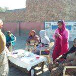 Healthcare workers conducting disease screening and community health outreach activities.