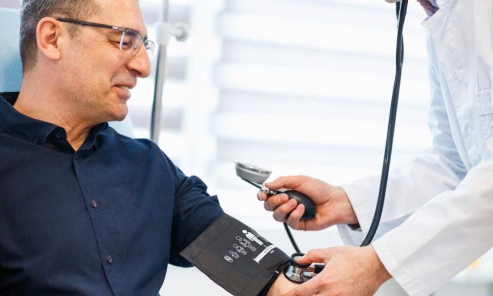 Healthcare professional conducting a blood pressure screening and heart health consultation.