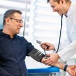 Healthcare professional conducting a blood pressure screening and heart health consultation.