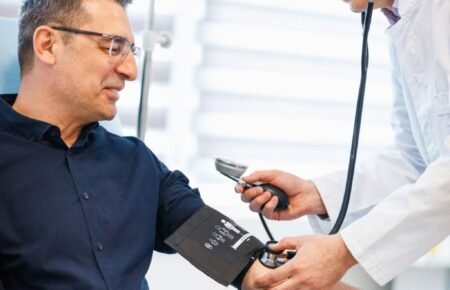 Healthcare professional conducting a blood pressure screening and heart health consultation.