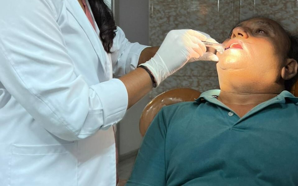 A doctor conducting an oral cancer examination with digital diagnostic support.