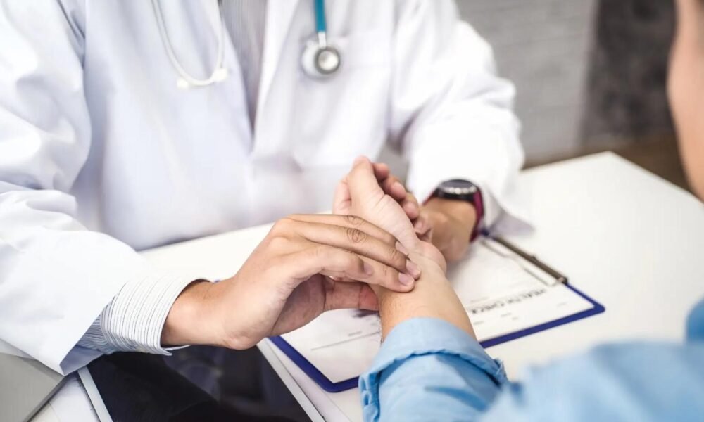 Doctor consulting a patient about viral fever symptoms in Kerala.
