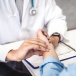 Doctor consulting a patient about viral fever symptoms in Kerala.