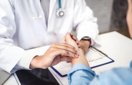 Doctor consulting a patient about viral fever symptoms in Kerala.