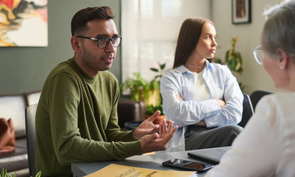 Mental health professional providing counselling support to a young adult.