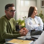 Mental health professional providing counselling support to a young adult.