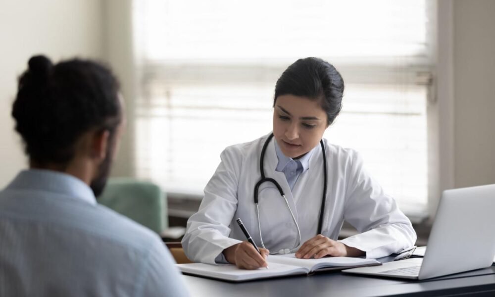 Doctor consulting a patient about safe medication practices in Kerala.