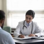 Doctor consulting a patient about safe medication practices in Kerala.