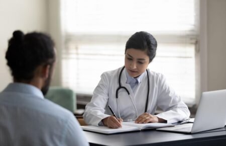 Doctor consulting a patient about safe medication practices in Kerala.