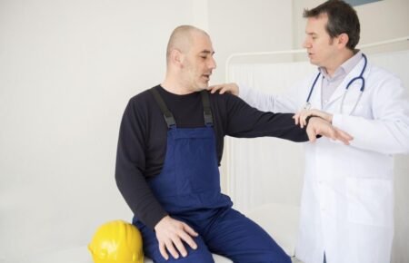 A doctor conducting a health check-up for construction workers at a medical camp.