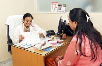 A doctor communicating with a patient during a consultation in a hospital.