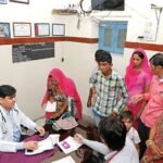 Doctor providing healthcare services at a government primary health centre in rural India.