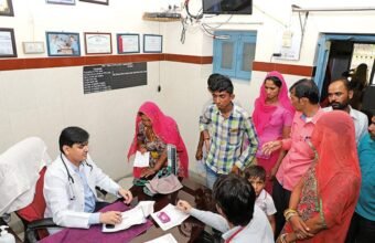 Doctor providing healthcare services at a government primary health centre in rural India.