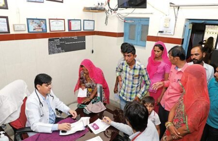 Doctor providing healthcare services at a government primary health centre in rural India.