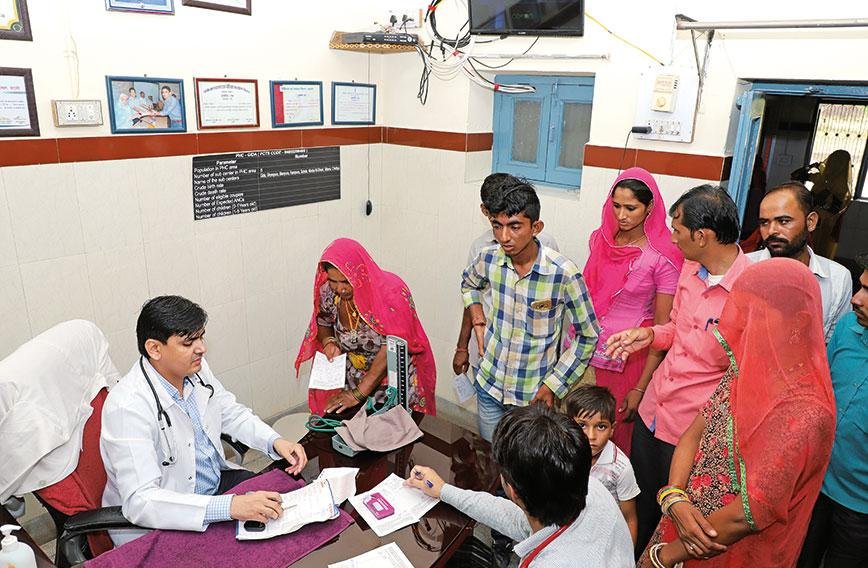 Doctor providing healthcare services at a government primary health centre in rural India.