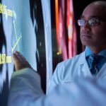 A doctor using AI-assisted software to review cancer screening images.