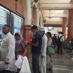 Doctor using a digital health record system in a government hospital.