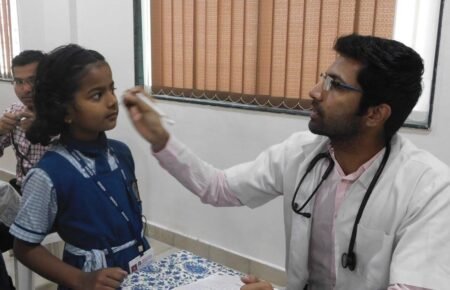 Doctors conducting health check-ups for schoolchildren during a school health screening programme.
