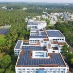 A hospital equipped with rooftop solar panels as part of a sustainable healthcare initiative.
