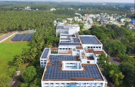 A hospital equipped with rooftop solar panels as part of a sustainable healthcare initiative.