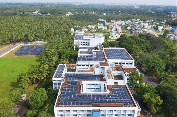 A hospital equipped with rooftop solar panels as part of a sustainable healthcare initiative.