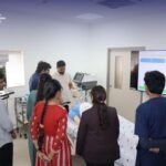 Medical students receiving hands-on training using a patient simulation mannequin.