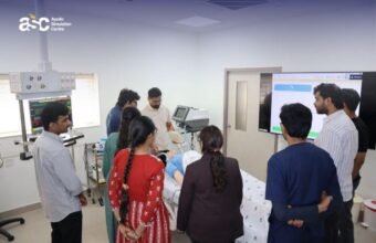 Medical students receiving hands-on training using a patient simulation mannequin.