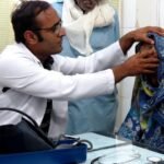 Doctors providing healthcare services at a government hospital under the National Health Mission.